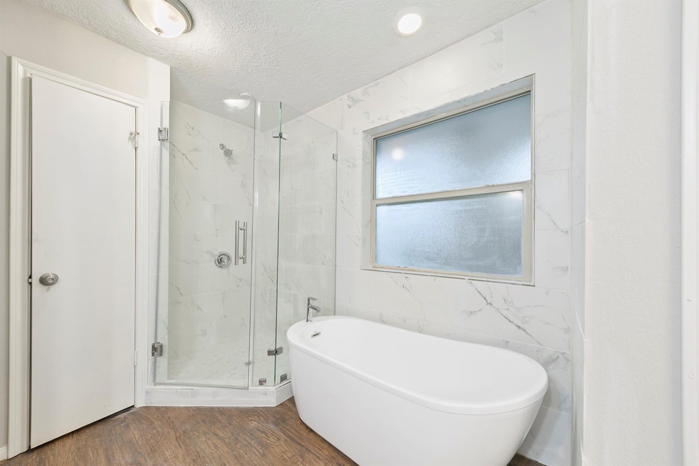 Completed Greater Houston bathroom renovation with glass shower and freestanding tub